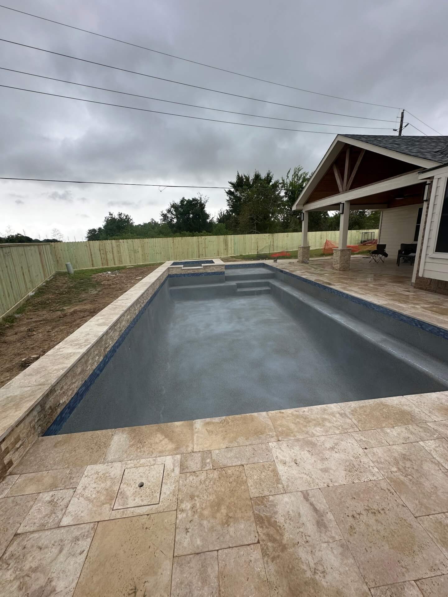 empty backyard pool in overcast portrait