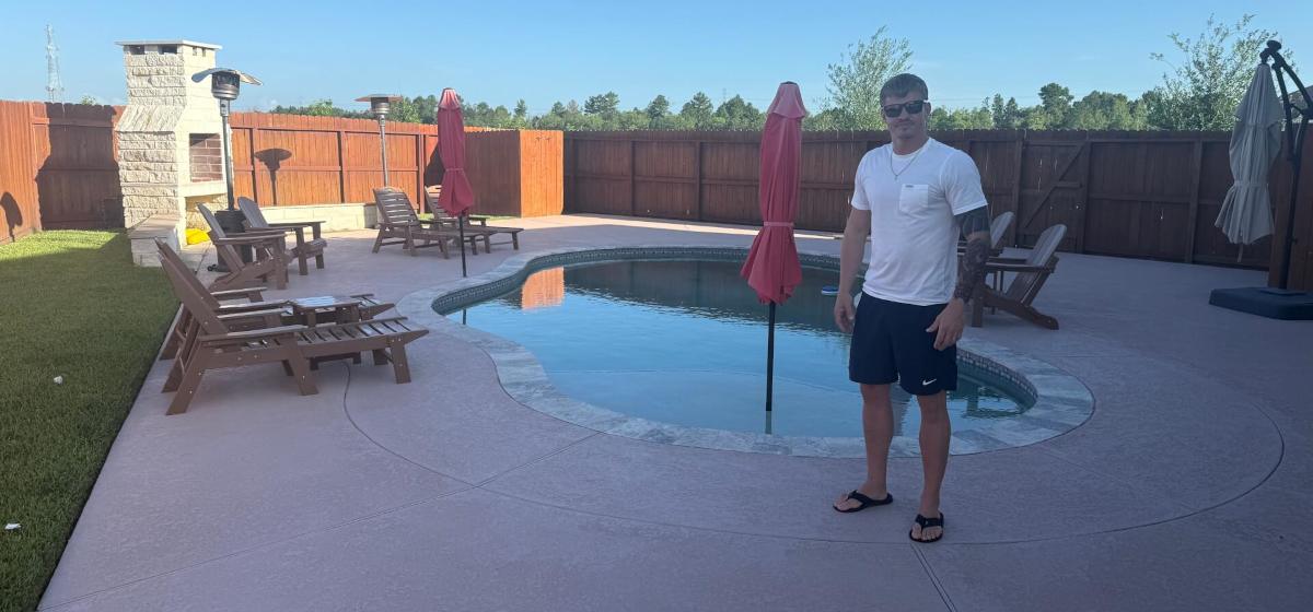 kbdc worker standing on backyard pool landscape